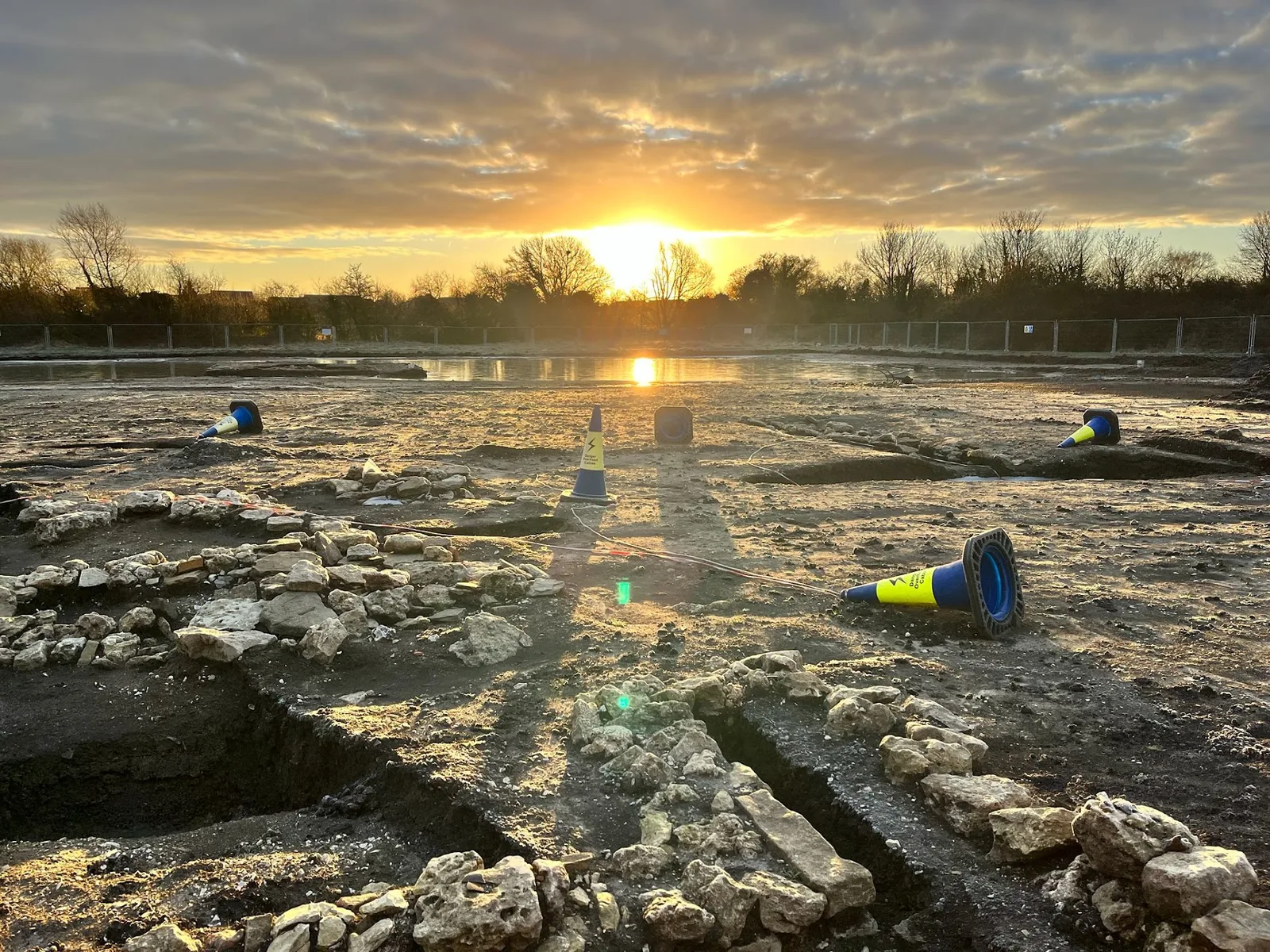 Wide archaeological fieldwork site at the start of a working day