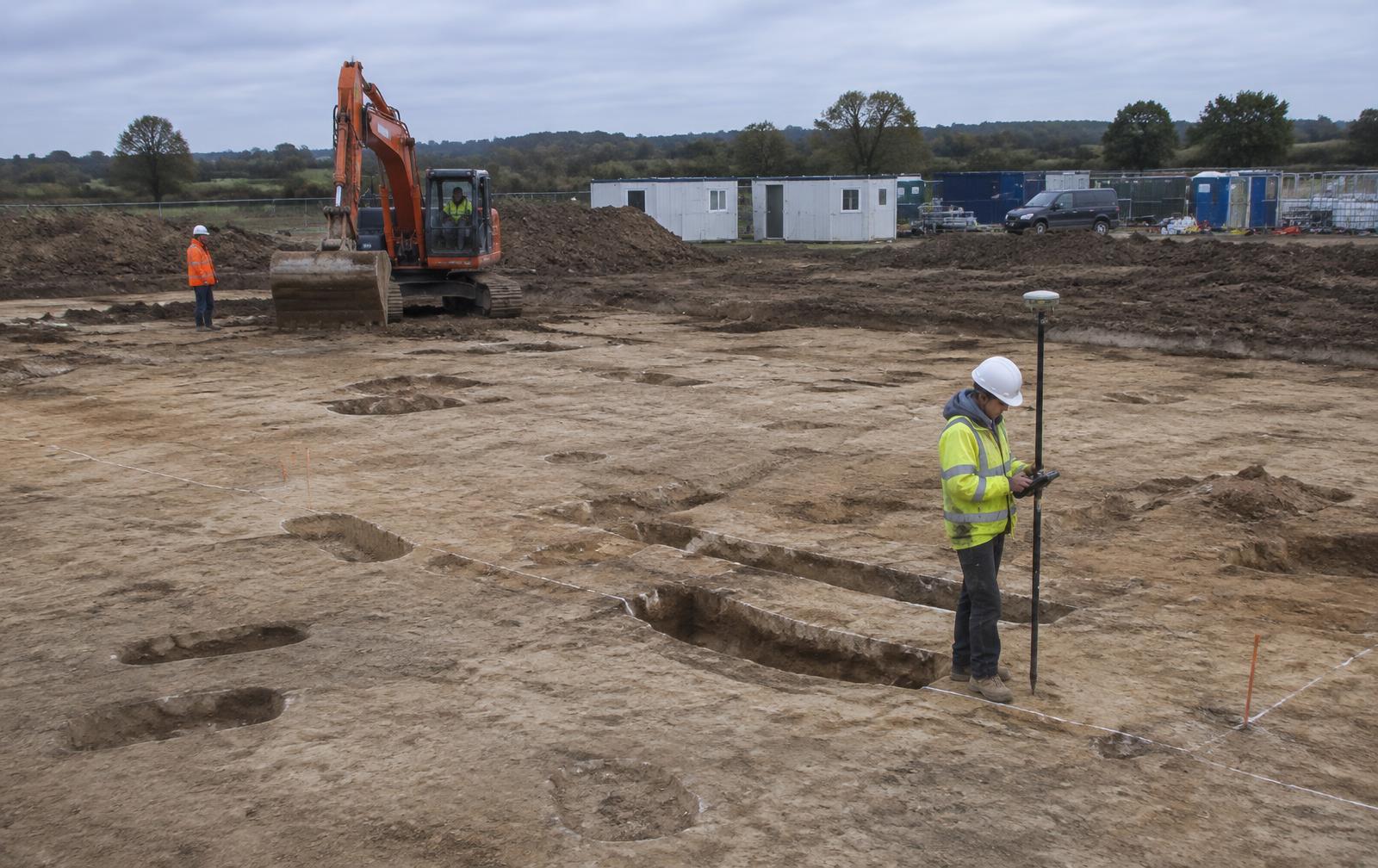 Strip, map and sample excavation area with exposed archaeological features